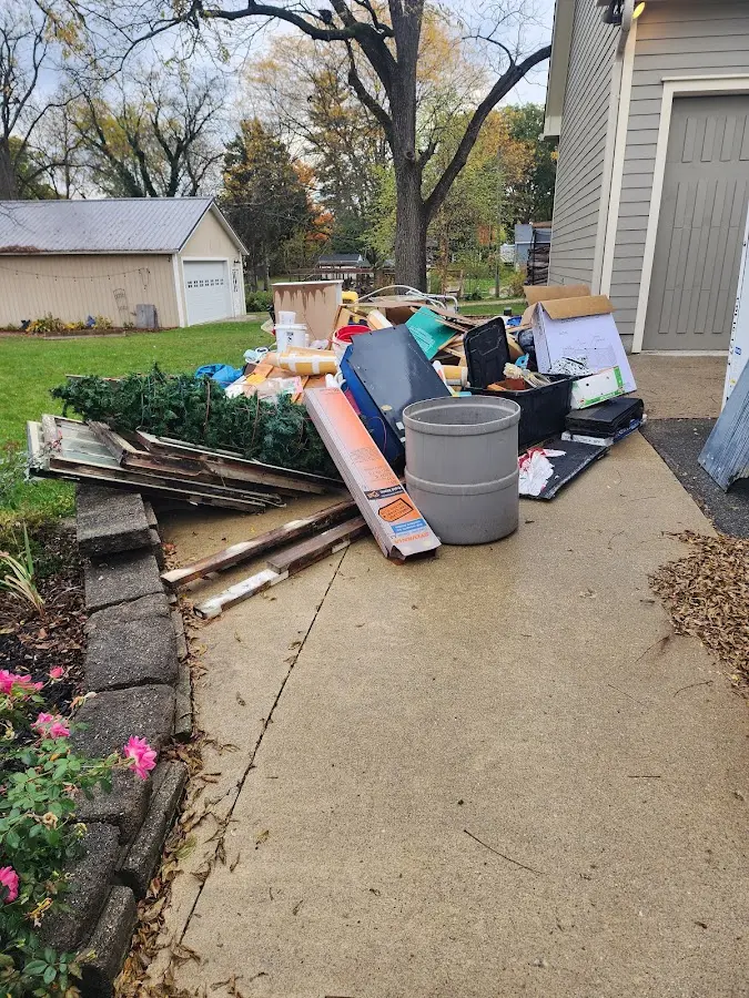 Dumpster being loaded with debris for Demolition Dumpster Rental in Troy